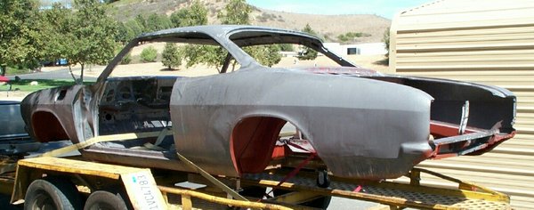 After a chemical dip and red oxide coating on the underside, the body heads home for installation of a NOS rear cove from Clark's and repairs to the dented lft rear quarter.