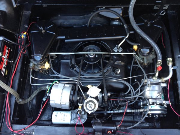 The engine compartment with the new alternator and the compressor unit.