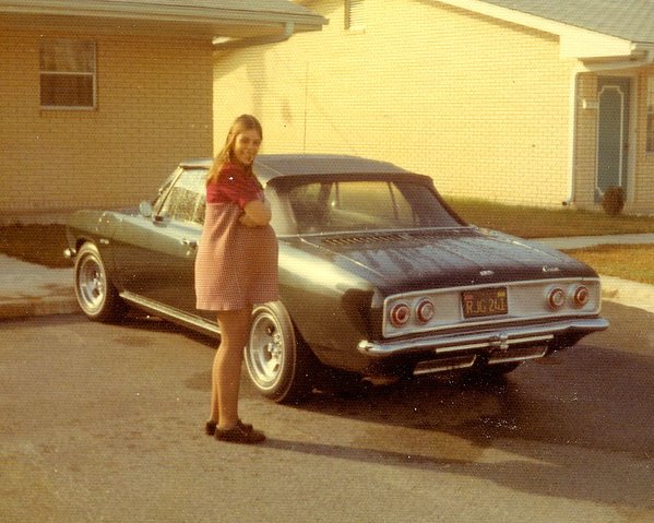 That same 1965 Corsa convertible (now dark green) with  my then pregnant wife while stationed in Warner Robins, GA in 1973