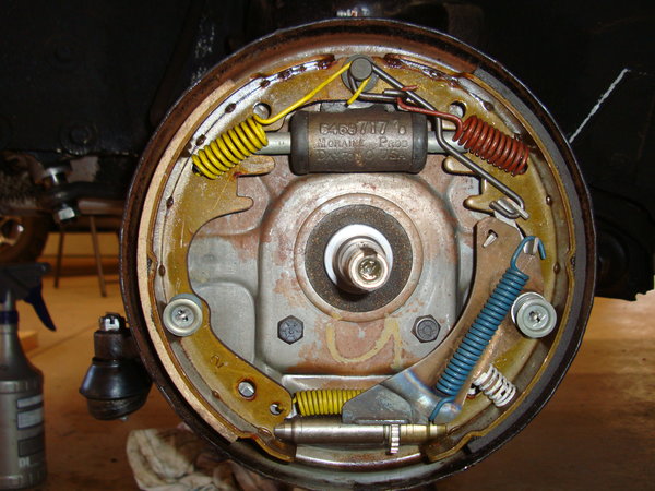as found condition, note undercoating on inside lip of backing plate and yellow inspection marker (for bolting).  All wheels had this marking.  Also note large brake pad to rear all wheels