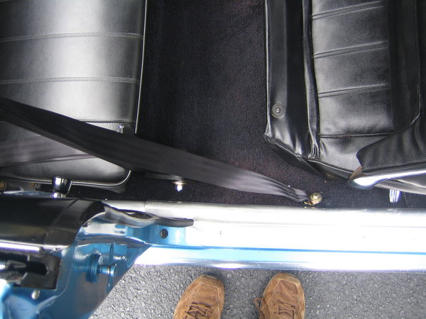 Outboard belts.  Lap belt to factory location.  Inertia reel required hole to be drilled in floor.
