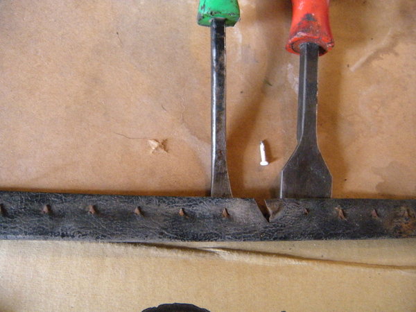The original pins were spotwelded into the thin metal strip.  I lifted the metal so that the drill does not damage the cardboard, and drilled the hold leftover from where the spot weld pulled out, to the diameter of the finishing nail.  I used those white finishing nails that have ridges along the length, and cut them shorter and re sharpened the tip.