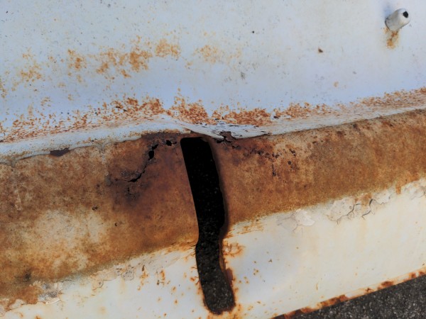 This is the slot for the front right bumper bracket that goes through the center section. Notice rust through along the top of the &quot;chin&quot;, assume that this proceeds along the entire &quot;chin&quot;
