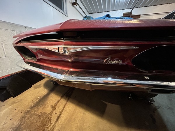 Bumper, chrome, and emblem installed.  Also the empty headlight buckets.  (The trunk key is in the lock)