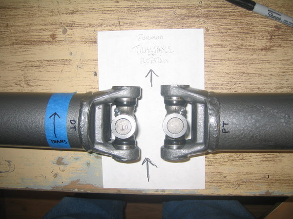 Visual on DT and PT shafts with appropriate grease fitting locations.  Note mark to ease installation.  Set the shafts up in a mock up position before you start. Visualize forward rotation and place the grease fittings between the drive trunnion and the driven trunnion.  Place your mark so you don't have to think to much about it while you are doing the actual press work.