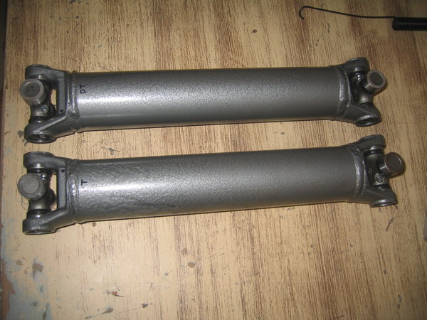 Done.  I will grease them when I put them back on the car.  If you want to grease the U-joints before you re install, you can put the loose ends of the joint loosely in a vise or a large C-clamp and grease it then so the ends won't pop off.
